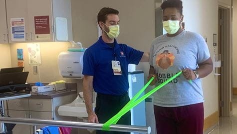 Janai Mitchell works with physical therapist Bryce Showers